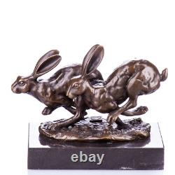 Bronze sculpture of racing rabbits on a black marble base after Nick