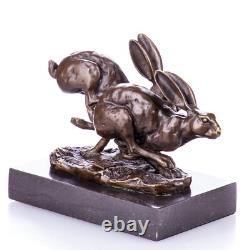 Bronze sculpture of racing rabbits on a black marble base after Nick