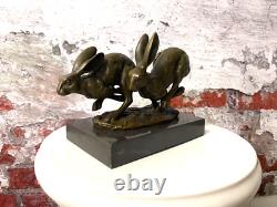 Bronze sculpture of running rabbits on a black marble base after Nick