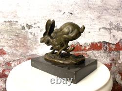 Bronze sculpture of running rabbits on a black marble base after Nick