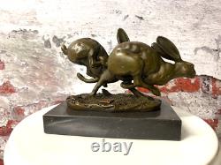Bronze sculpture of running rabbits on a black marble base after Nick