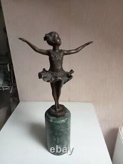 Bronze statuette of a dancer signed, 33 cm in height on a green marble base