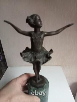 Bronze statuette of a dancer signed, 33 cm in height on a green marble base