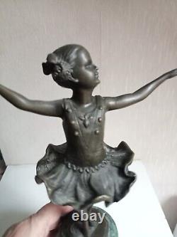 Bronze statuette of a dancer signed, 33 cm in height on a green marble base