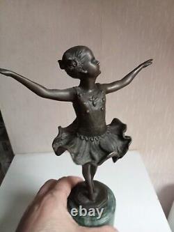 Bronze statuette of a dancer signed, 33 cm in height on a green marble base