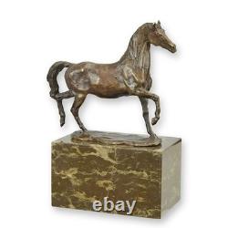 Bronze trotting horse sculpture on a black marble base, signed