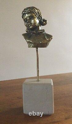 Bust of a little girl. Gilded bronze/marble base. Monogrammed PM. 10x7x5. Height 25.