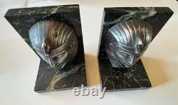 C. CHARLES Pair of Art Deco bookends, bronze pharaohs on marble. Signed