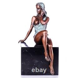 Colored bronze figure of a nude female on a black marble Signed