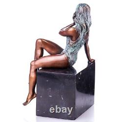 Colored bronze figure of a nude female on a black marble Signed