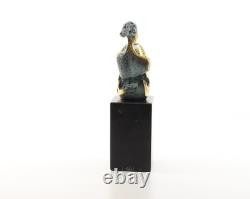 Colored sculpture of a woman in bronze on a black marble base after Nick