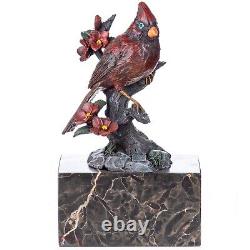 Colorful bronze bird sculpture on a branch on a Vintage signed marble