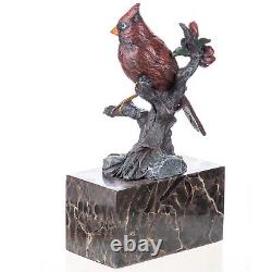 Colorful bronze bird sculpture on a branch on a Vintage signed marble