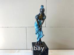 Colorful bronze female sculpture on a black marble base after Milo