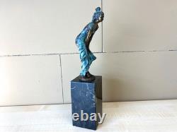 Colorful bronze female sculpture on a black marble base after Milo