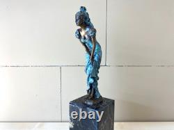 Colorful bronze female sculpture on a black marble base after Milo