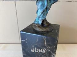 Colorful bronze female sculpture on a black marble base after Milo