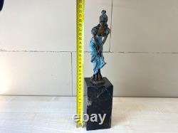 Colorful bronze female sculpture on a black marble base after Milo