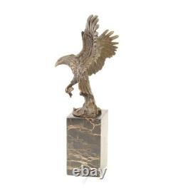 Eagle sculpture with fish in bronze on black marble after Milo