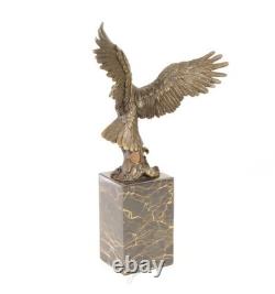 Eagle sculpture with fish in bronze on black marble after Milo