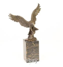 Eagle sculpture with fish in bronze on black marble after Milo