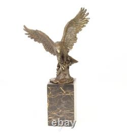 Eagle sculpture with fish in bronze on black marble after Milo