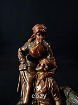 Georges Omerth bronze sculpture on marble of a nurse caring for a soldier