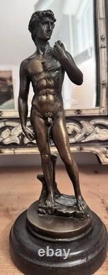 Michelangelo bronze statue of a nude man, signed, on a marble base, 20th century