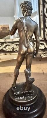 Michelangelo bronze statue of a nude man, signed, on a marble base, 20th century