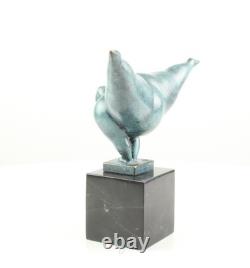 Modern bronze sculpture of a naked woman on black marble after Milo