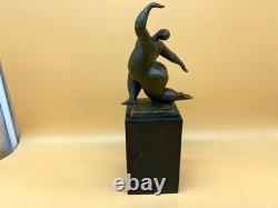 Modern bronze sculpture of a nude woman on black marble after Milo
