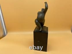 Modern bronze sculpture of a nude woman on black marble after Milo