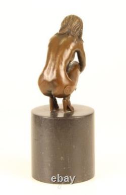 Sculpture of a Nude Woman Sitting in Bronze on a Black Marble Base after Claude