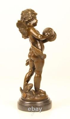 Sculpture of a Putto playing Cymbals in bronze on black marble signed