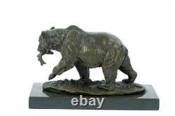 Sculpture of a bear with fish in bronze on a black marble base after Milo