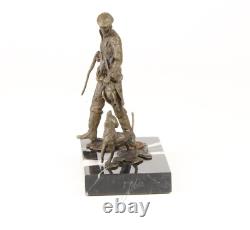 Sculpture of a hunter with a dog on black marble signed