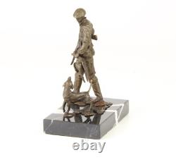 Sculpture of a hunter with a dog on black marble signed