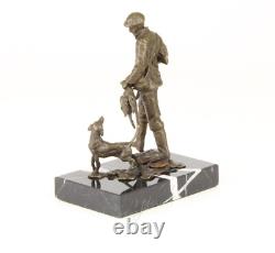Sculpture of a hunter with a dog on black marble signed