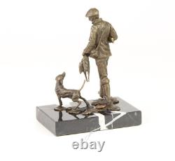 Sculpture of a hunter with a dog on black marble signed