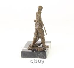 Sculpture of a hunter with a dog on black marble signed