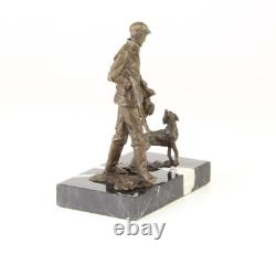 Sculpture of a hunter with a dog on black marble signed