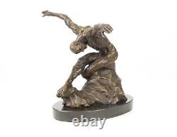 Sculpture of a nude modern dancer in bronze on black marble after Milo