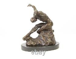 Sculpture of a nude modern dancer in bronze on black marble after Milo