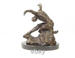 Sculpture of a nude modern dancer in bronze on black marble after Milo