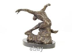 Sculpture of a nude modern dancer in bronze on black marble after Milo