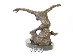 Sculpture of a nude modern dancer in bronze on black marble after Milo