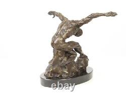 Sculpture of a nude modern dancer in bronze on black marble after Milo