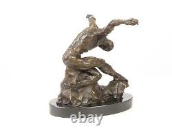 Sculpture of a nude modern dancer in bronze on black marble after Milo