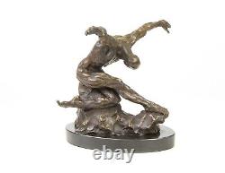 Sculpture of a nude modern dancer in bronze on black marble after Milo