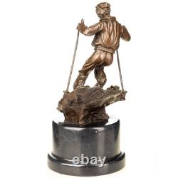 Sculpture of a skier in bronze on a black marble base after Nick